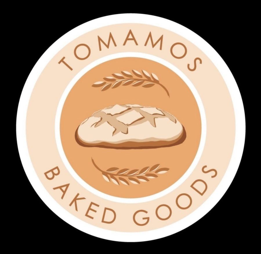 Tomamos Baked Goods logo — a scored sourdough boule between two wheat sheaves, ringed by the words Tomamos Baked Goods
